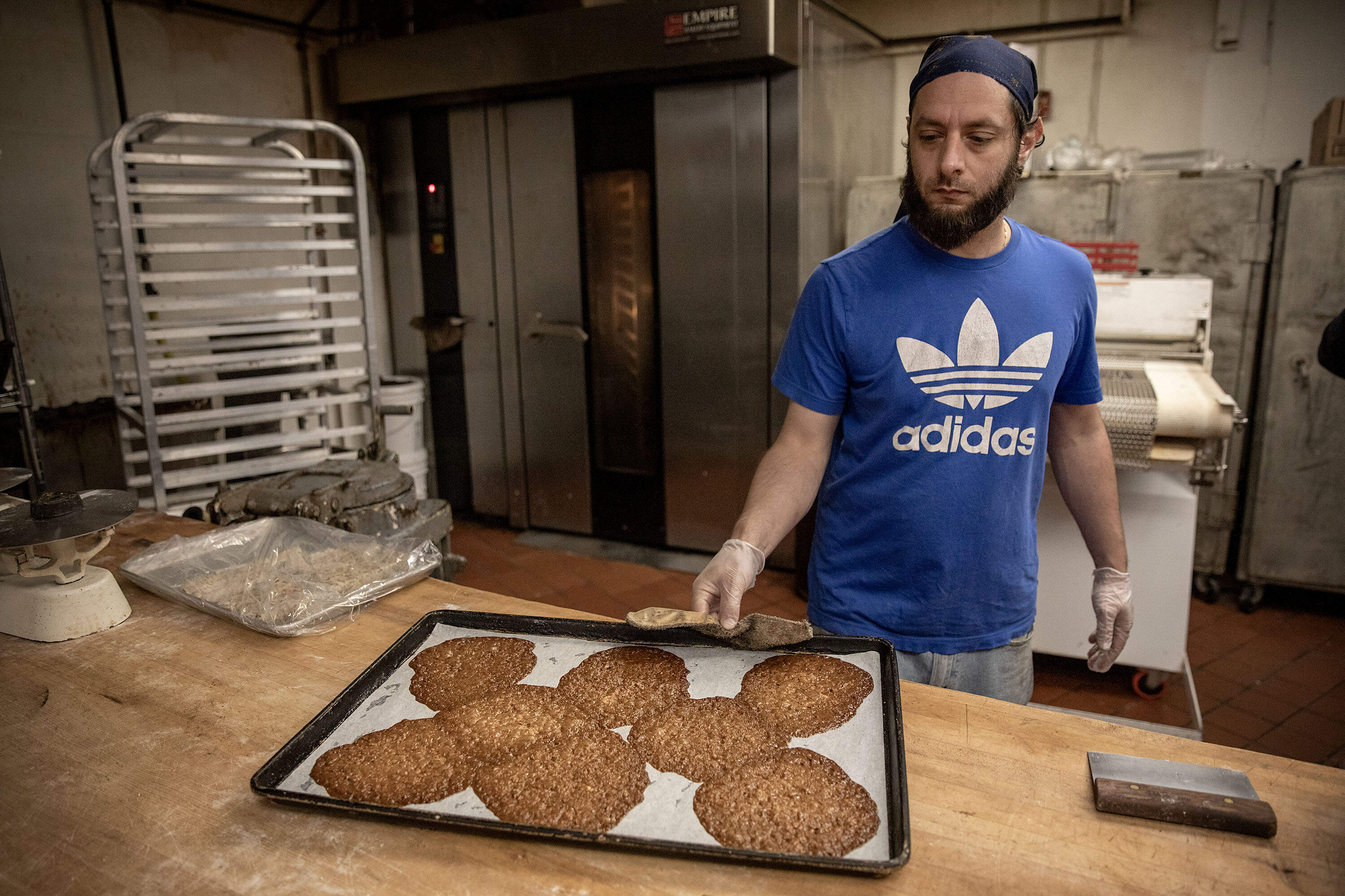 Jojo Bova pulls a tray of Florentine cannoli shells fresh from the oven. (Robin Lubbock/WBUR)