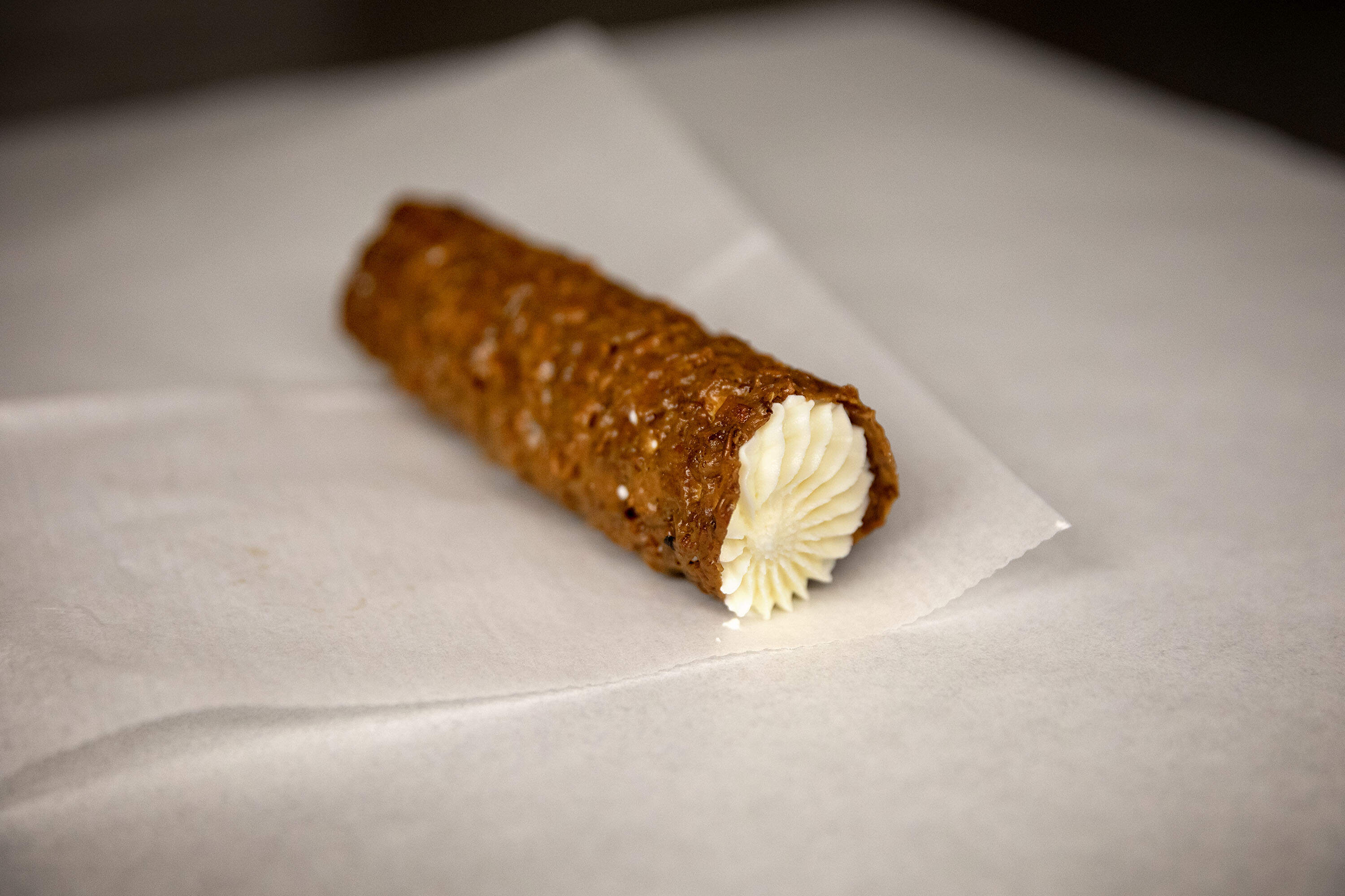 A filled cannoli ready for sale at Bova's Bakery in Boston's North End. (Robin Lubbock/WBUR)