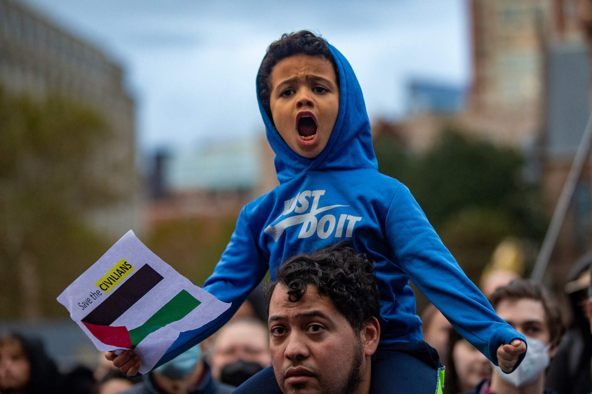 A young protestor shouts during a pro-Palestinian rally in front of the Boston Public Library in Copley Square. (Jesse Costa/WBUR)