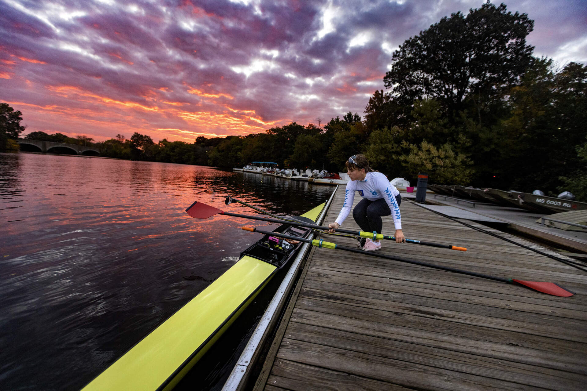 Rower Maria Prodan sets out onto the Charles River to practice for the Head of the Charles. (Jesse Costa/WBUR)