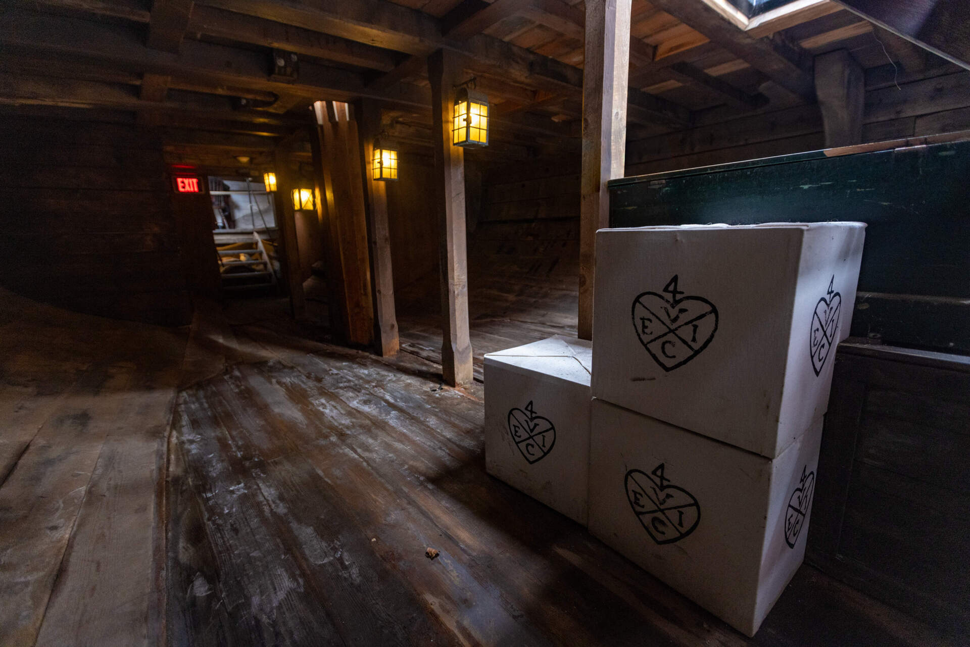 Crates with the emblem of the East India Company sit below deck of the brig Beaver at the Boston Tea Party Museum. (Jesse Costa/WBUR)