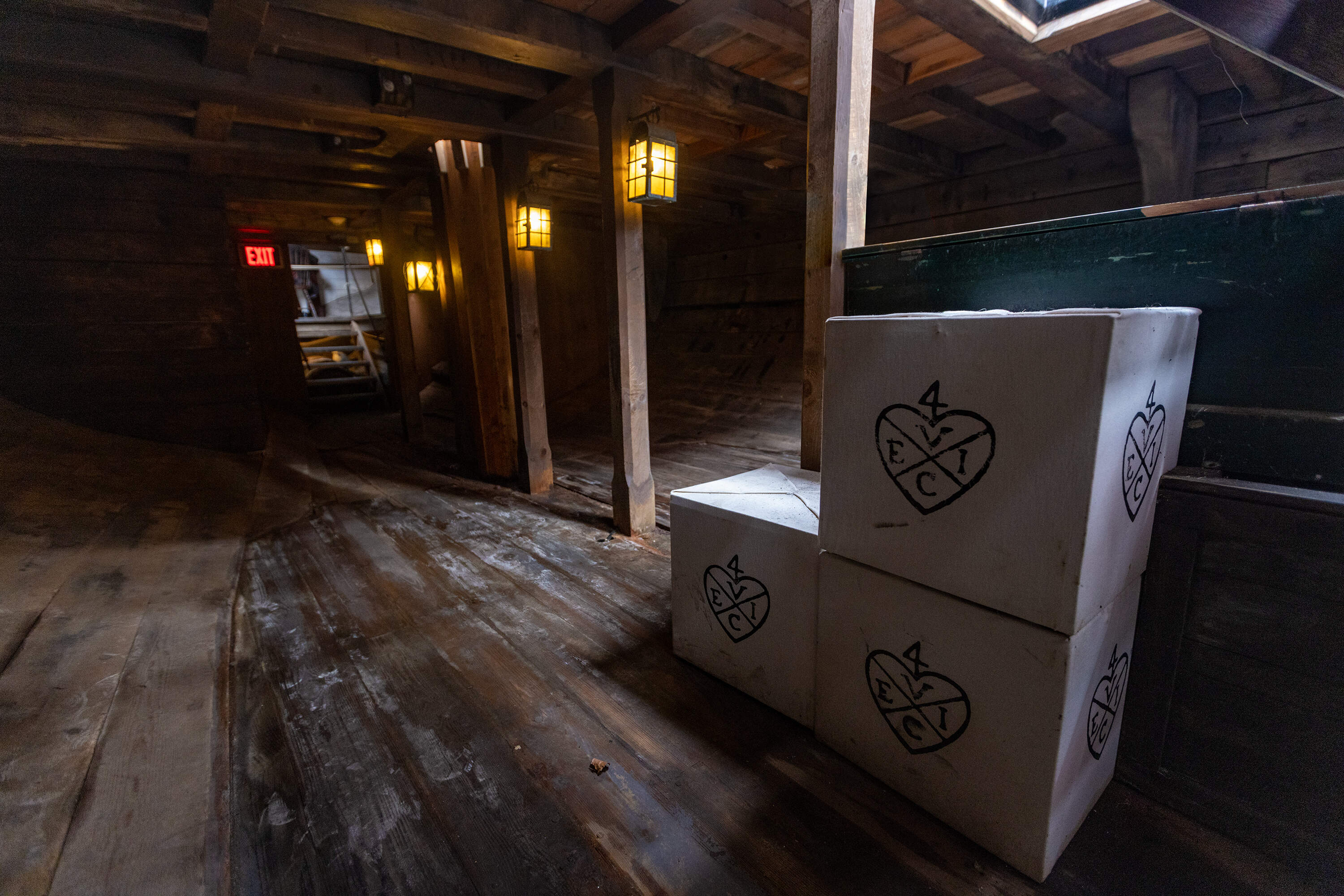 Crates with the emblem of the East India Company sit below deck of the brig Beaver at the Boston Tea Party Museum. (Jesse Costa/WBUR)