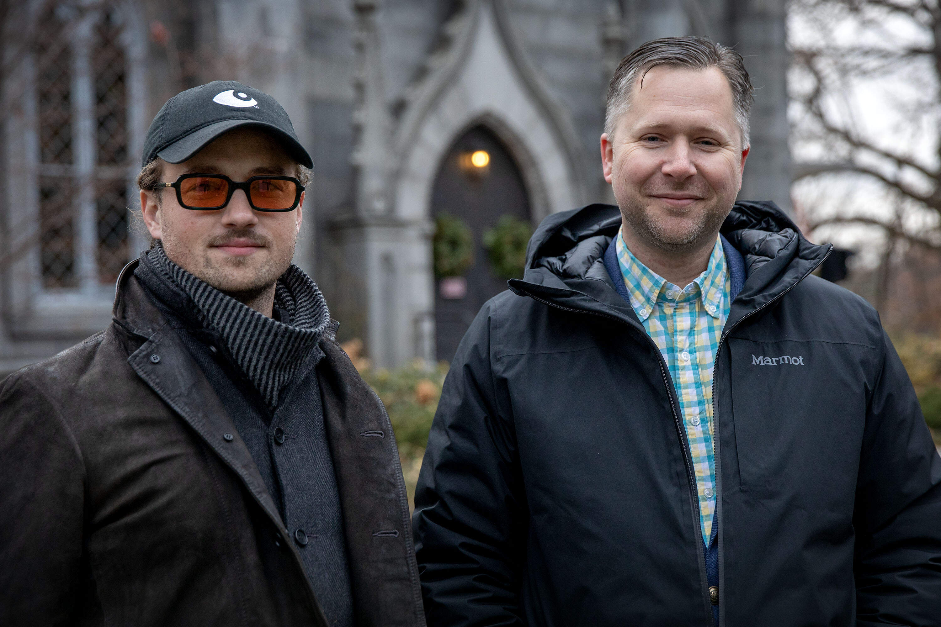 MASARY media artist Sam Okerstrom-Lang and Mount Auburn Cemetery president and CEO Matthew Stephens, outside Bigelow Chapel. (Robin Lubbock/WBUR)