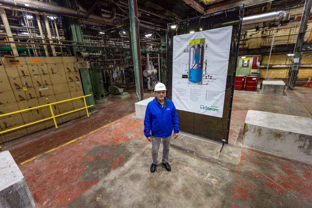 Vicinity Energy's Don Silvia stands where the newly acquired electric boiler will be installed at the Kendall plant in Cambridge. (Jesse Costa/WBUR)