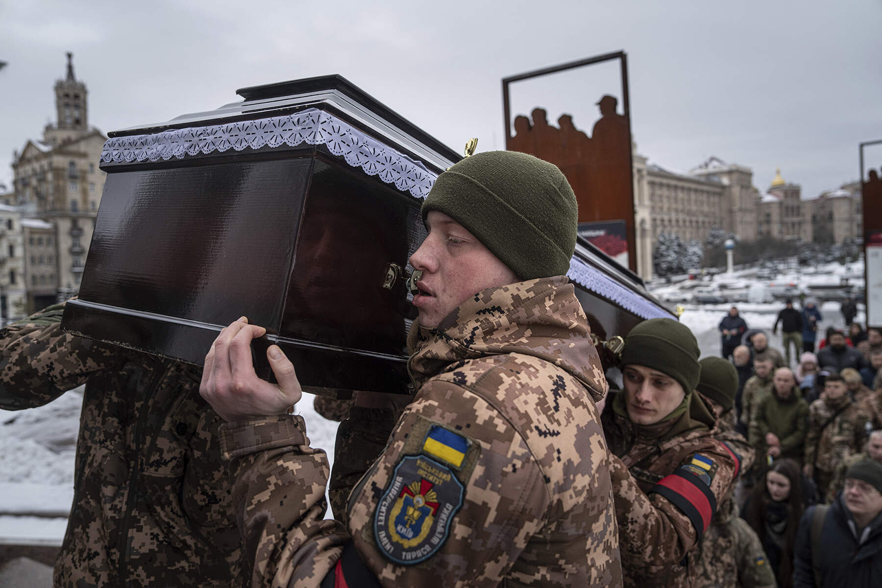 Honor guards carry the coffin of Andrii Trachuk, a Ukrainian serviceman, during his funeral service on Independence square in Kyiv, Ukraine, Friday, Dec. 15, 2023. Trachuk was a veteran of Revolution of Dignity and was killed by Russian forces on Dec. 9, 2023 near Kherson. (Evgeniy Maloletka/AP)