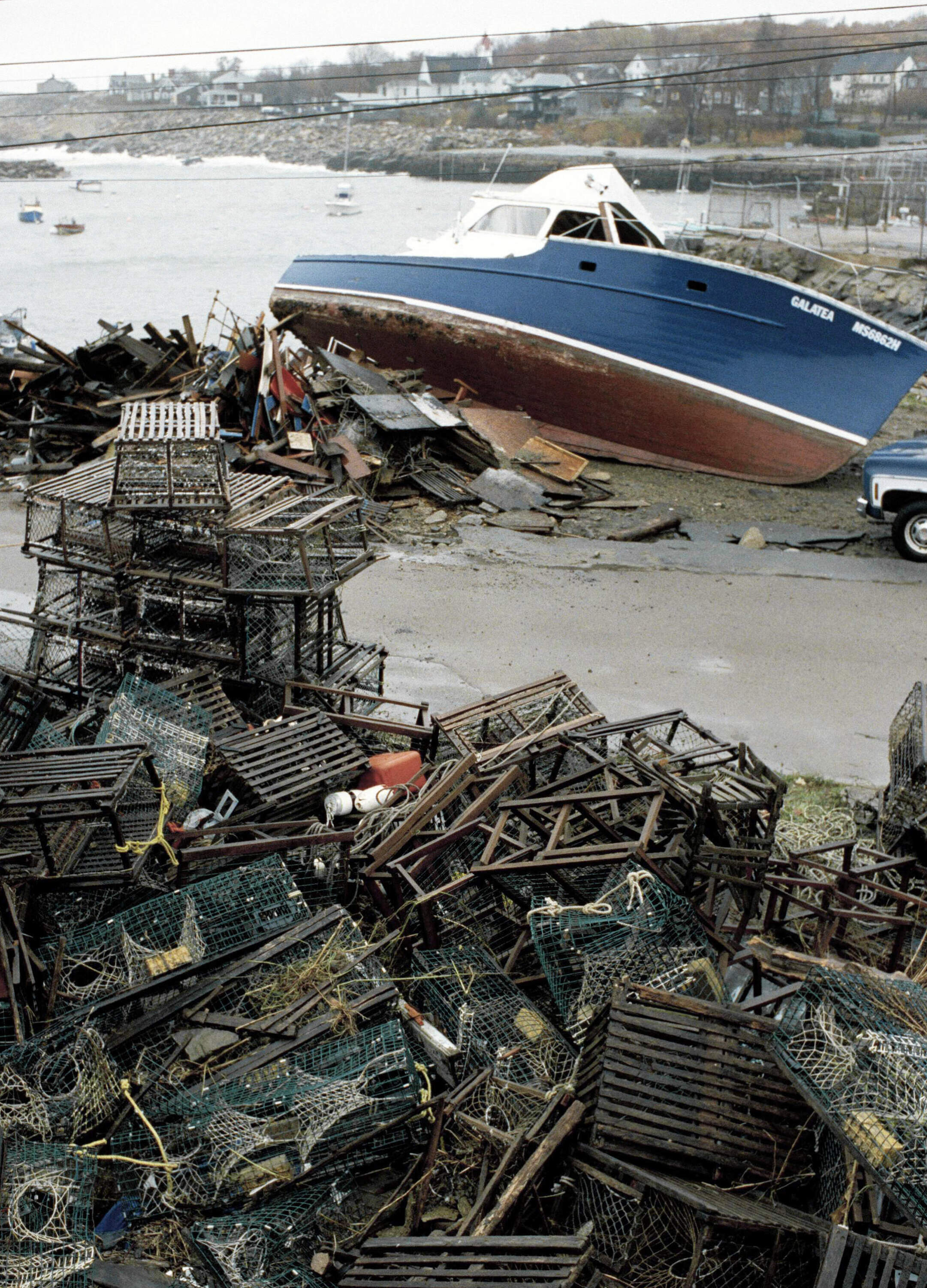 A large lobster boat and tangled lobster traps are seen wrecked along the shore in Rockport, Mass., Nov. 2, 1991. (Jon Chase/AP)