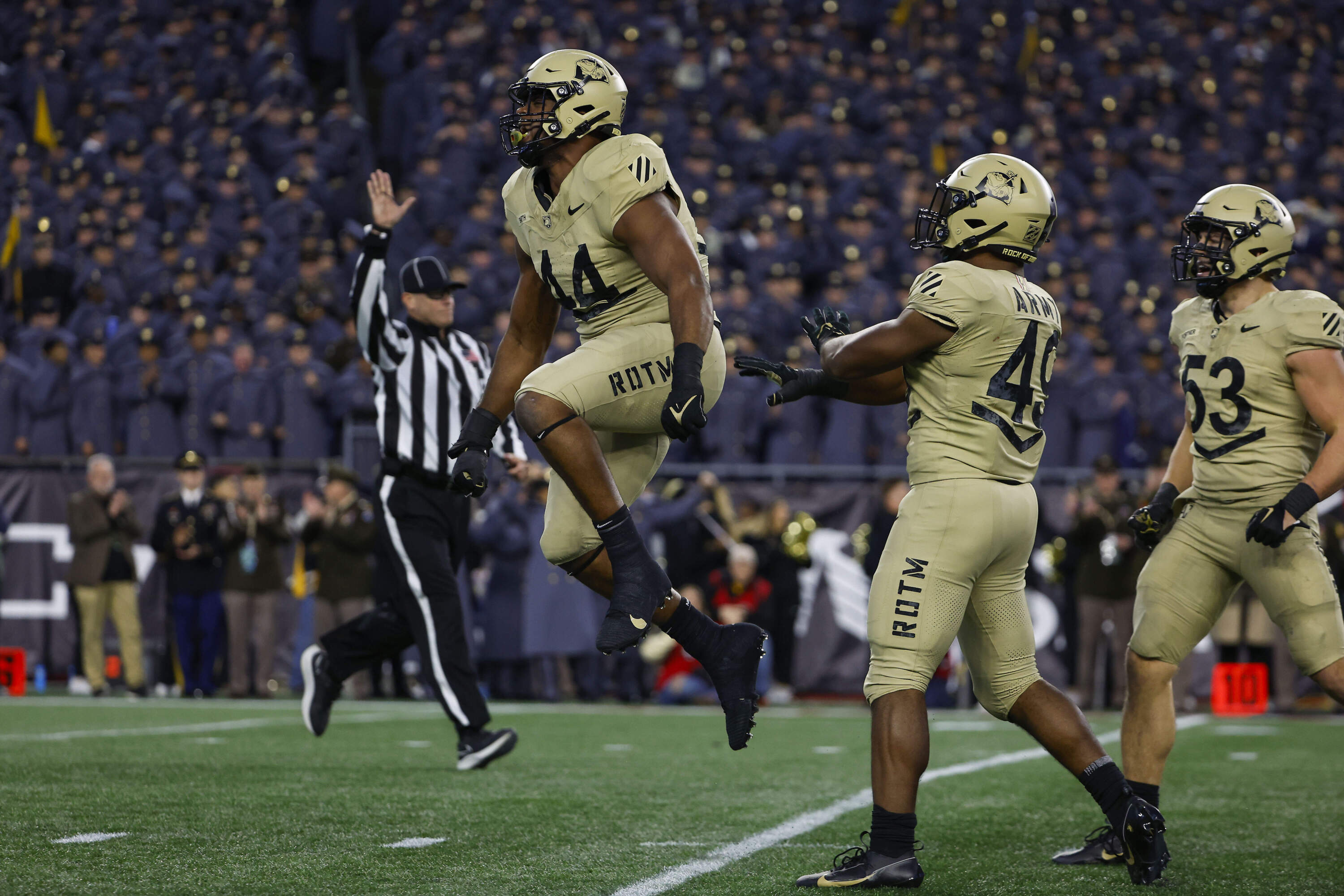 Army defensive lineman Nathaniel Smith (44) celebrates a sack against the Navy during the second quarter of a football game at Gillette Stadium. (Winslow Townson/AP)