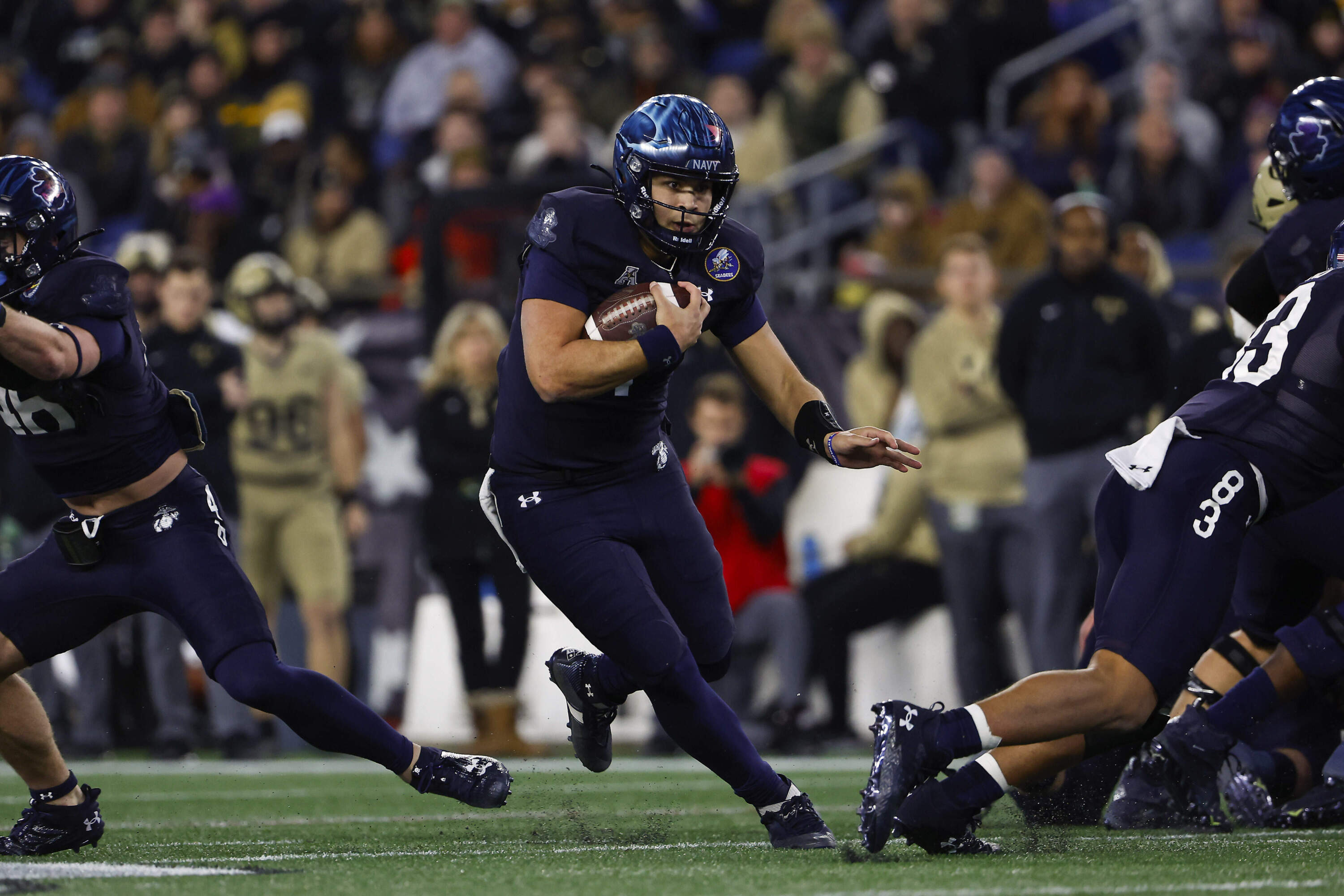 Navy quarterback Xavier Arline runs through a hole in the Army defense. (Winslow Townson/AP)