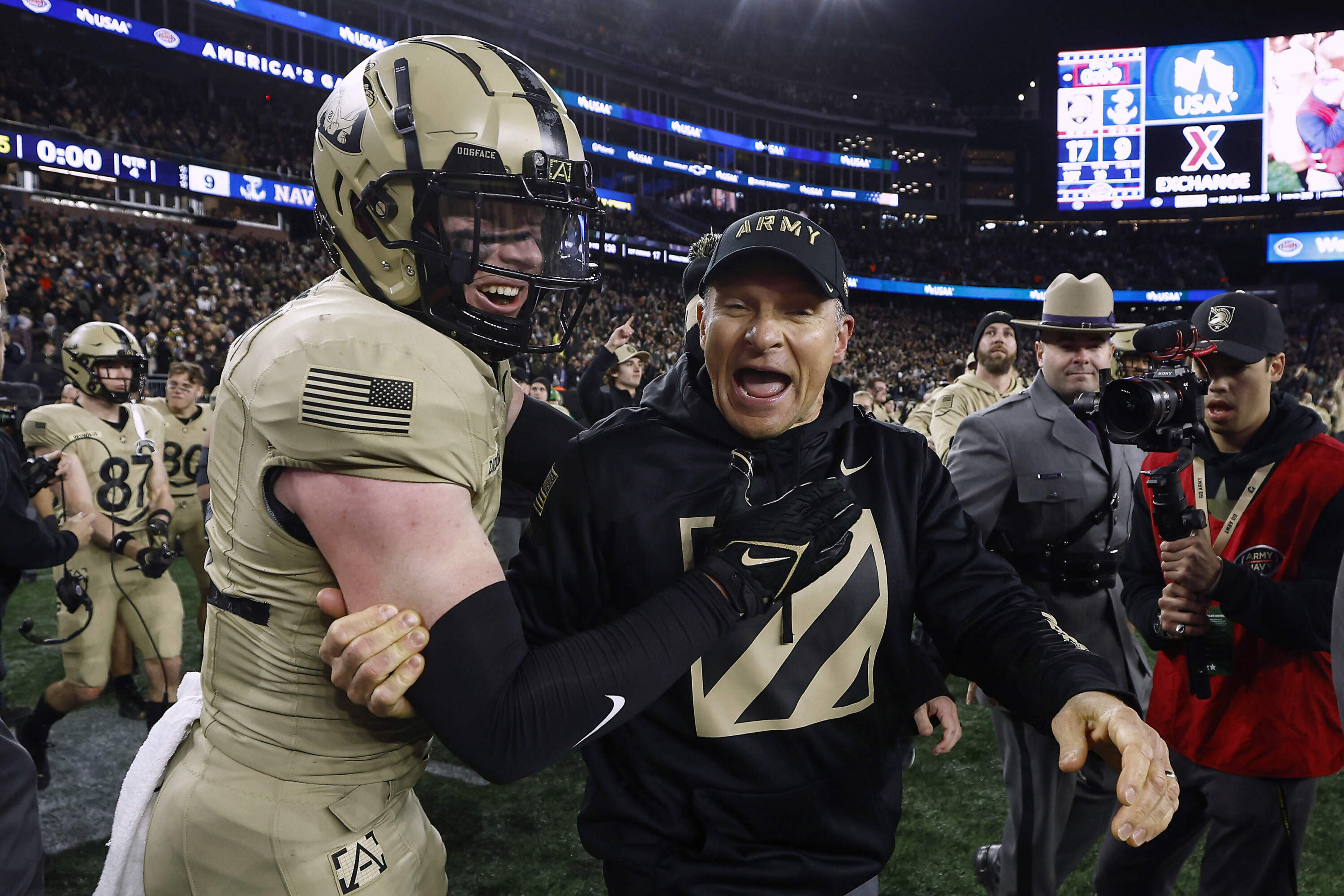 Army coach Jeff Monken celebrates with Max DiDomenico after the team's 17-11 win over Navy. (Winslow Townson/AP)