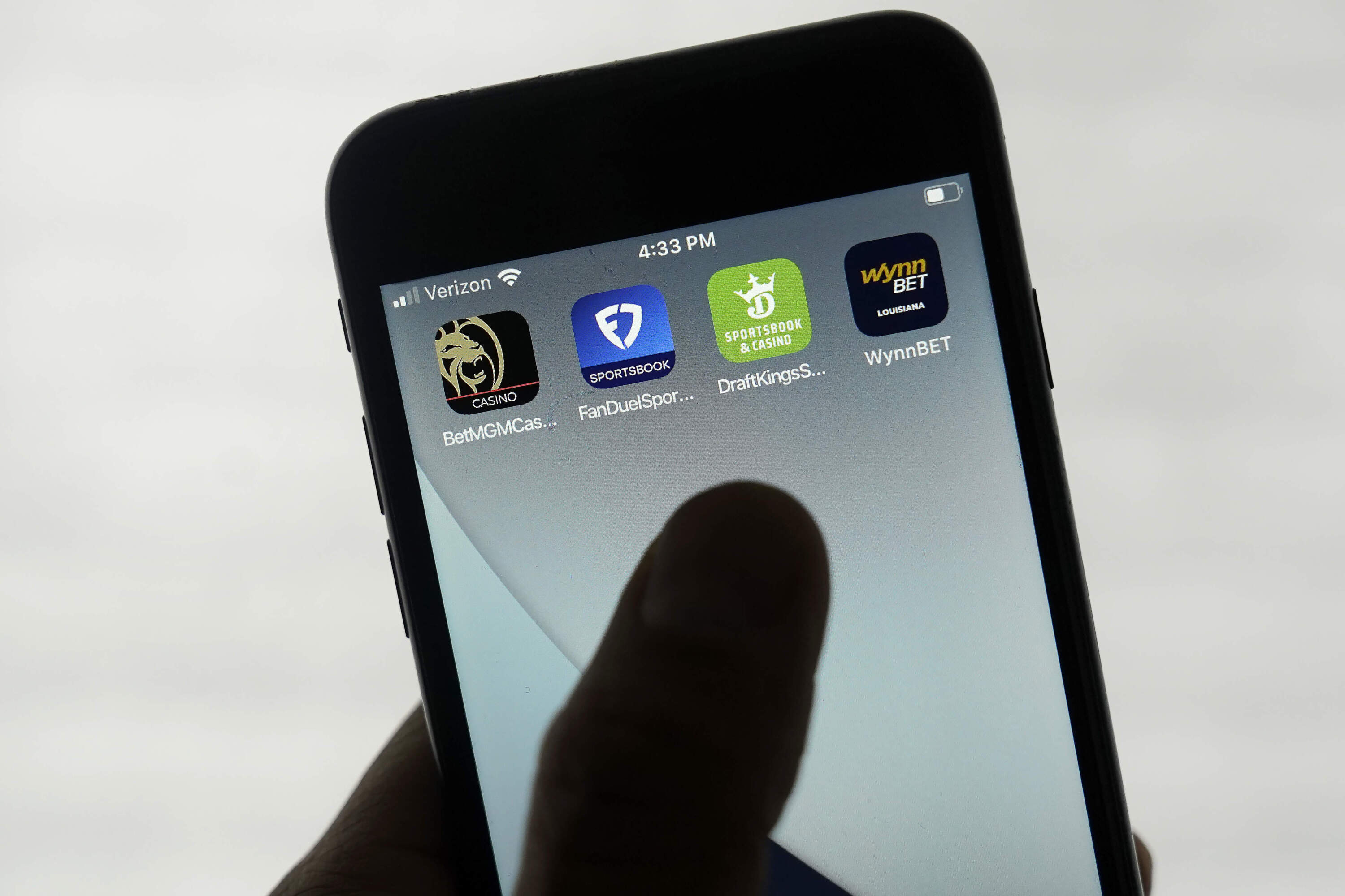 FanDuel, DraftKings and other online gambling apps are displayed on a phone. (Jeff Chiu/AP)