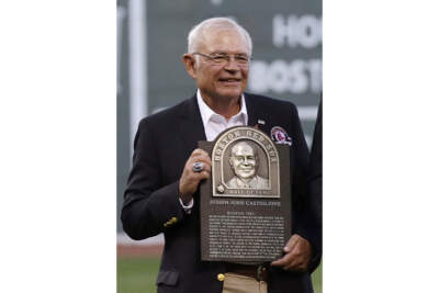 Boston Red Sox broadcaster Joe Castiglione, holds his Boston Red Sox Hall of Fame plaque before a baseball game at Fenway Park in 2014. (Charles Krupa/AP)