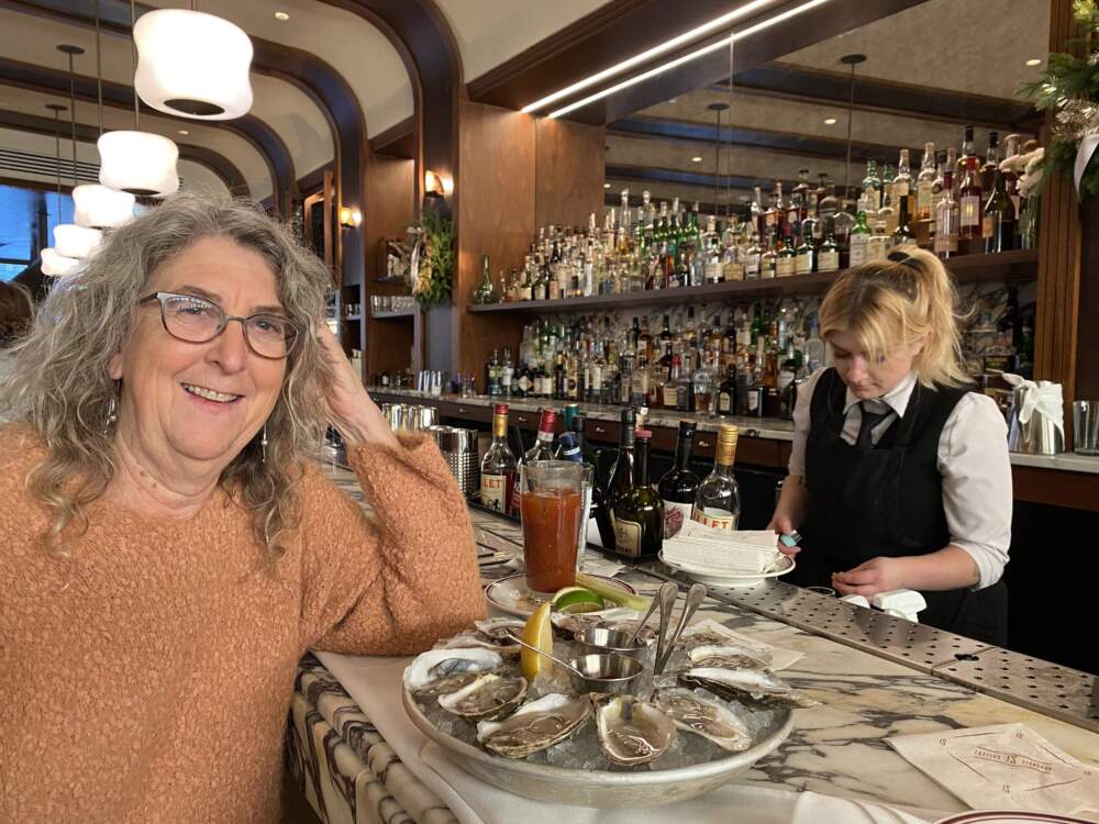 Food historian Susan Benjamin eating oysters at Eastern Standard in Boston. (Andrea Shea/WBUR)