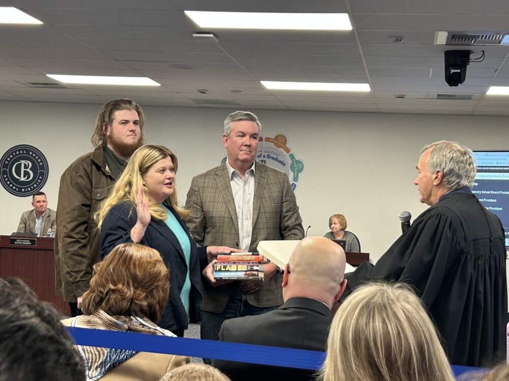 Central Bucks School Board President Karen Smith was sworn in Monday night on a stack of books that have been banned or challenged. (Courtesy of Karen Smith)