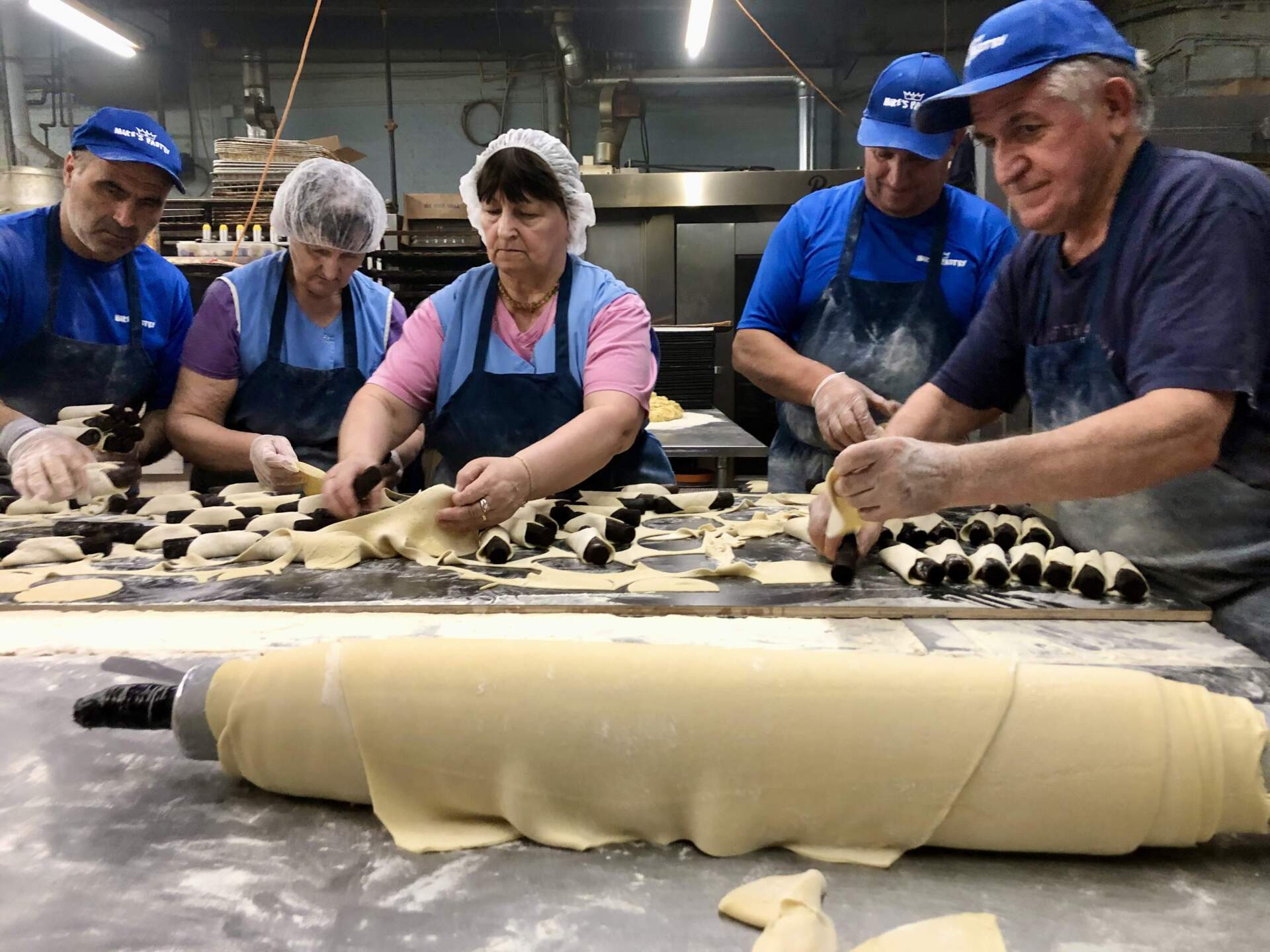 Employees at Mike's Pastry make traditional cannoli shells. (Lynn Jolicoeur/WBUR)