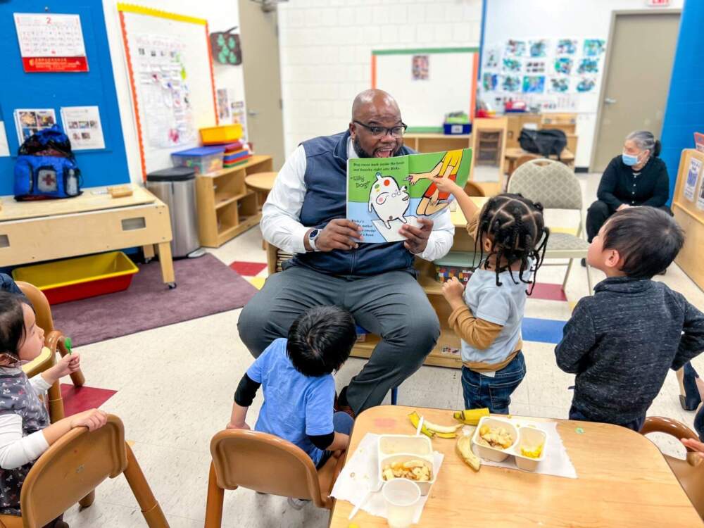 Massachusetts Secretary of Education Patrick Tutwiler reads to kids at the Wang YMCA of Chinatown. (Courtesy Executive Office of Education)