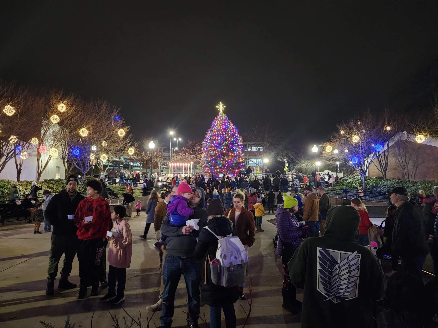 Several hundred people filled the streets of downtown Lewiston, Maine on Saturday Dec. 2, 2023 for a traditional holiday festival. It's been nearly six weeks since a mass shooting in the city left 18 dead and 13 injured. While some see these celebrations as a way to lift each other's spirits, others are still processing trauma and grief. (Susan Sharon/Maine Public)