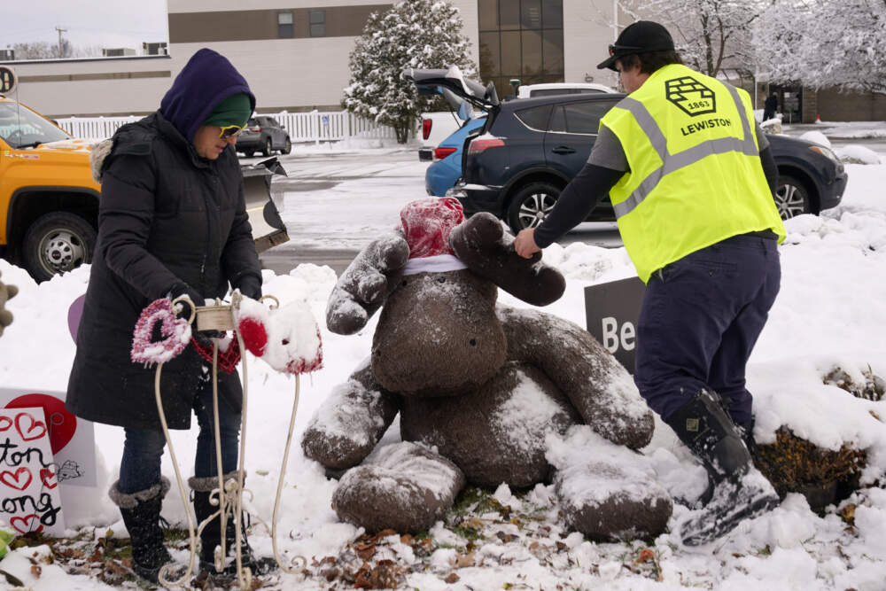 A large stuffed moose is cleared of snow before being packed away.(Robert F. Bukaty/AP)