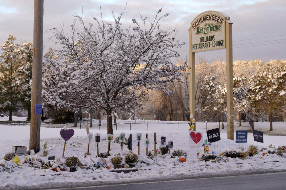 Snow dusts a memorial site outside Schemengees Bar &amp; Grille. (Robert F. Bukaty/AP)