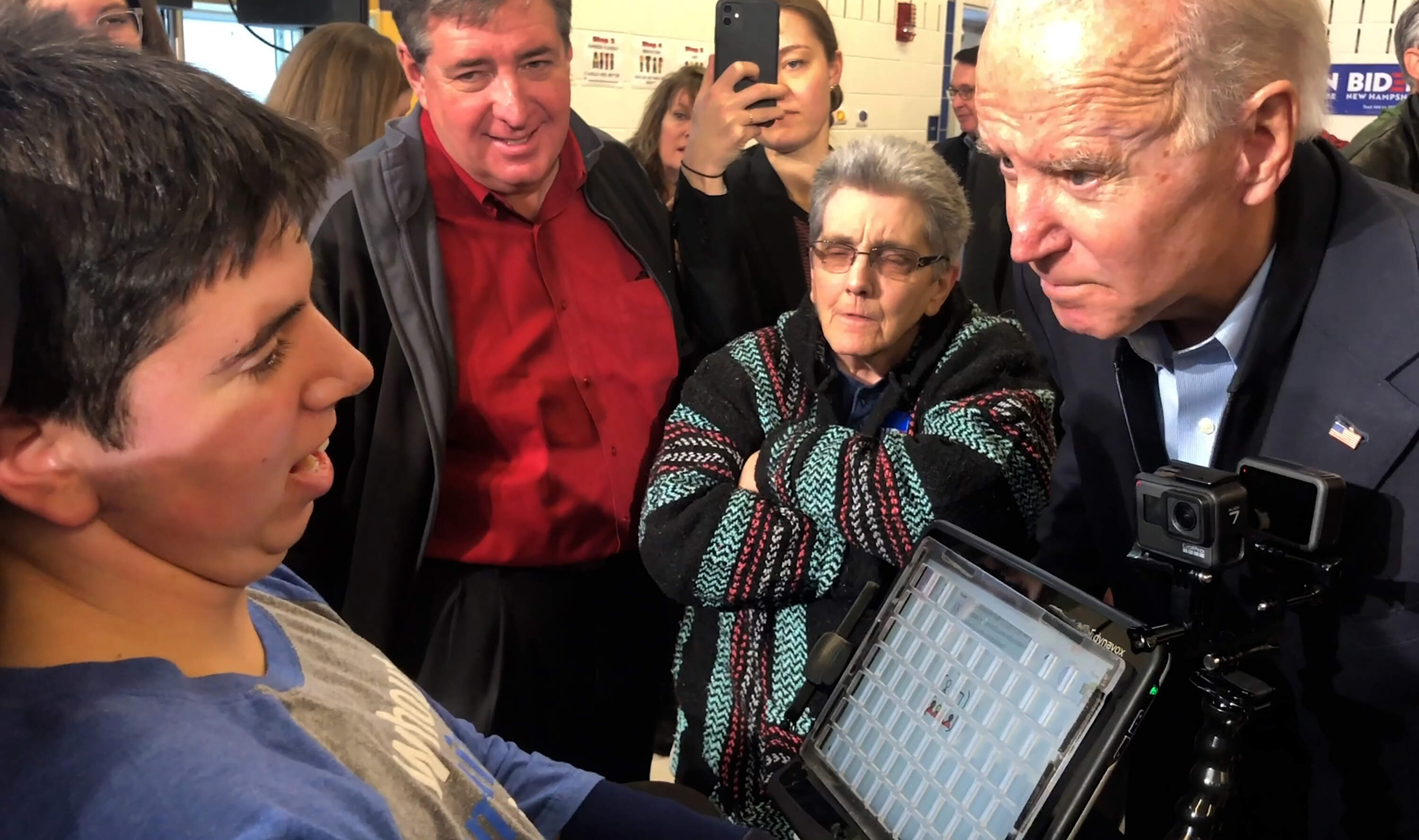 Samuel Habib, left, films with his two GoPro cameras during an encounter with then-Vice-President Joe Biden during the lead-up to the New Hampshire presidential primary in January 2020. Samuel was asking Biden about his stand on inclusiveeducation for students with disabilities, and during his answer Biden stroked Samuel’s face, creating a viral moment. (Dan Habib/LikeRightNow Films)