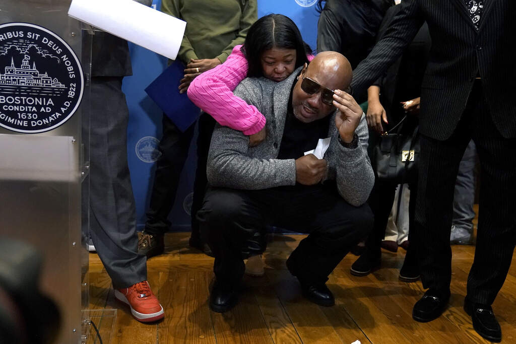 Joey Bennett, below, nephew of Willie Bennett, is comforted by a family member as he becomes emotional during a news conference. (Steven Senne/AP)