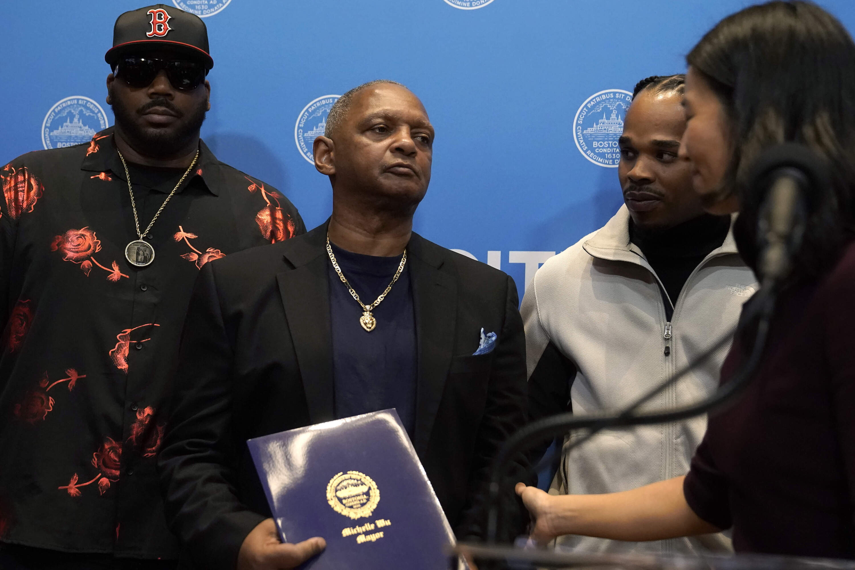 Alan Swanson, center left, is presented with a formal apology by Mayor Wu. (Steven Senne/AP)