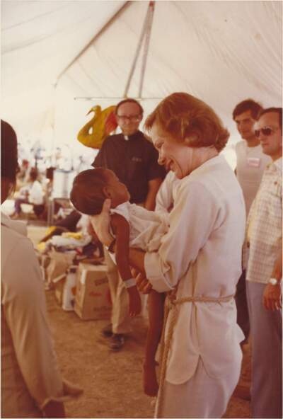 Former first lady Rosalynn Carter holds a baby at Sakeo, a Cambodian refugee camp, in 1979. The baby Carter is holding died soon after this photo was taken. (Courtesy of The Jimmy Carter Presidential Library)