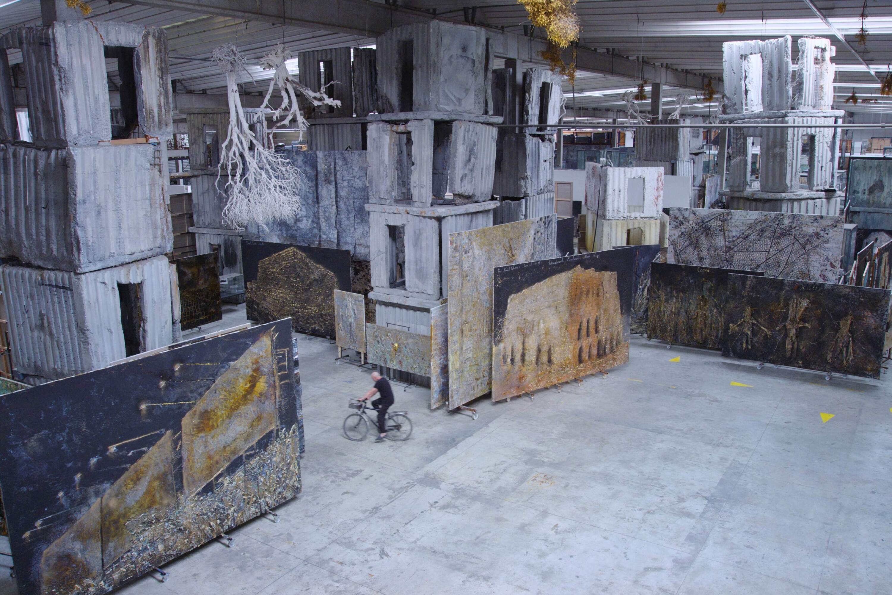 Anselm Kiefer rides his bike through his studio-estate, La Ribaute, in a still from the documentary "Anselm." (Courtesy Janus Films)