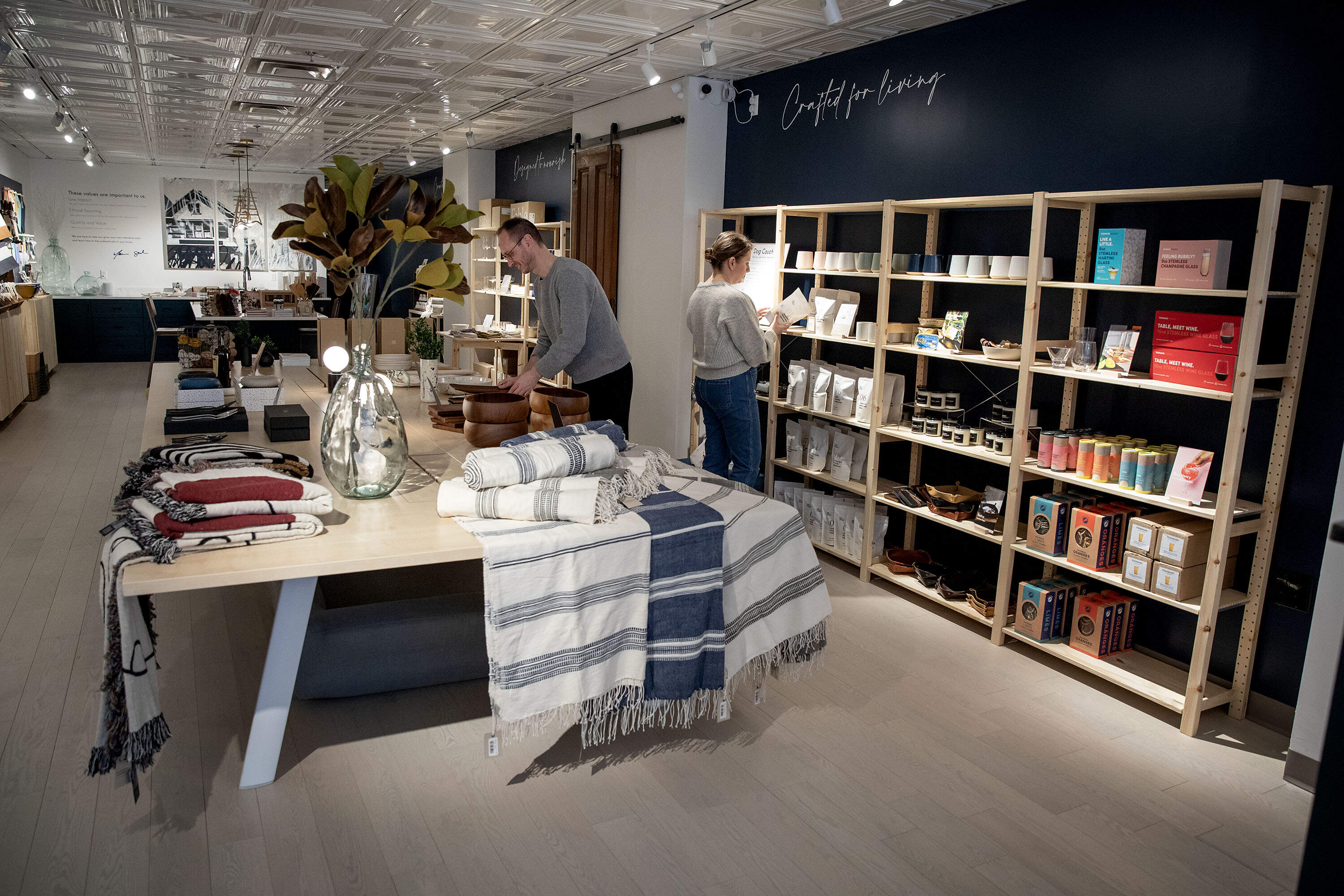 Co-owners Marcus Hamblin and Sarah Marchione, look through some items at Flourish &amp; Foundry on Tremont Street in Boston. (Robin Lubbock/WBUR)