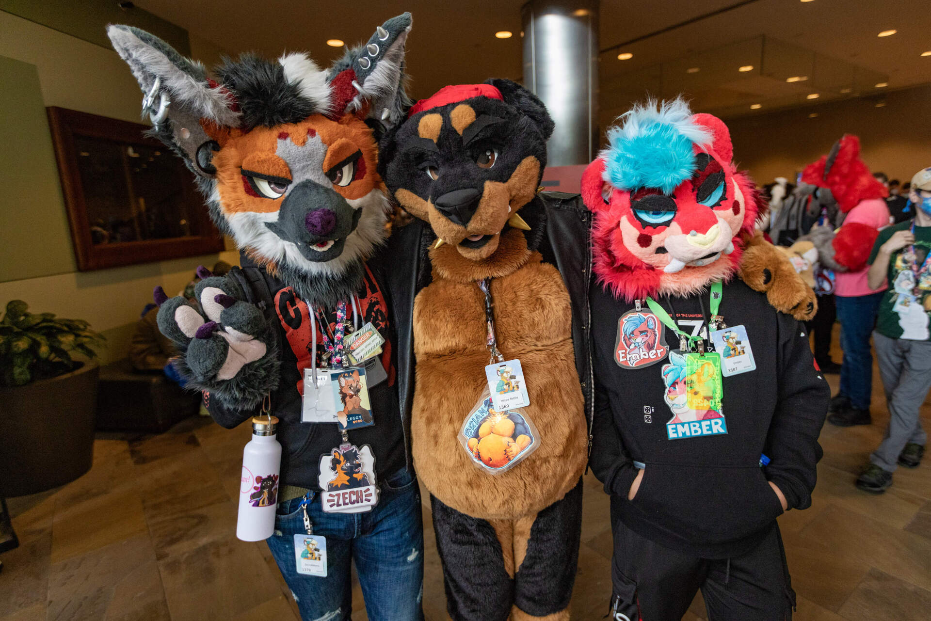 Zack Snodgrass a.k.a Zech, a maned wolf from Philadelphia; Brian Pyle a.k.a Brian, a Rottweiler also from Philly; and Brandon Gonzalez a.k.a Ember, a sabertooth tiger who traveled from Mexico to attend the Anthro New England conference. (Jesse Costa/WBUR)