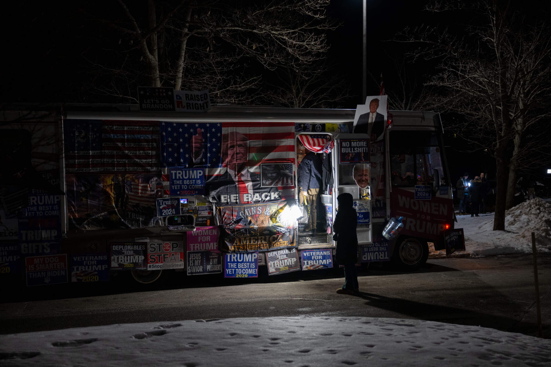 A person looks at a pro-Donald Trump RV outside the Sheraton Nashua on Tuesday, following Trump’s win in the New Hampshire primary. (Raquel C. Zaldívar/New England News Collaborative)