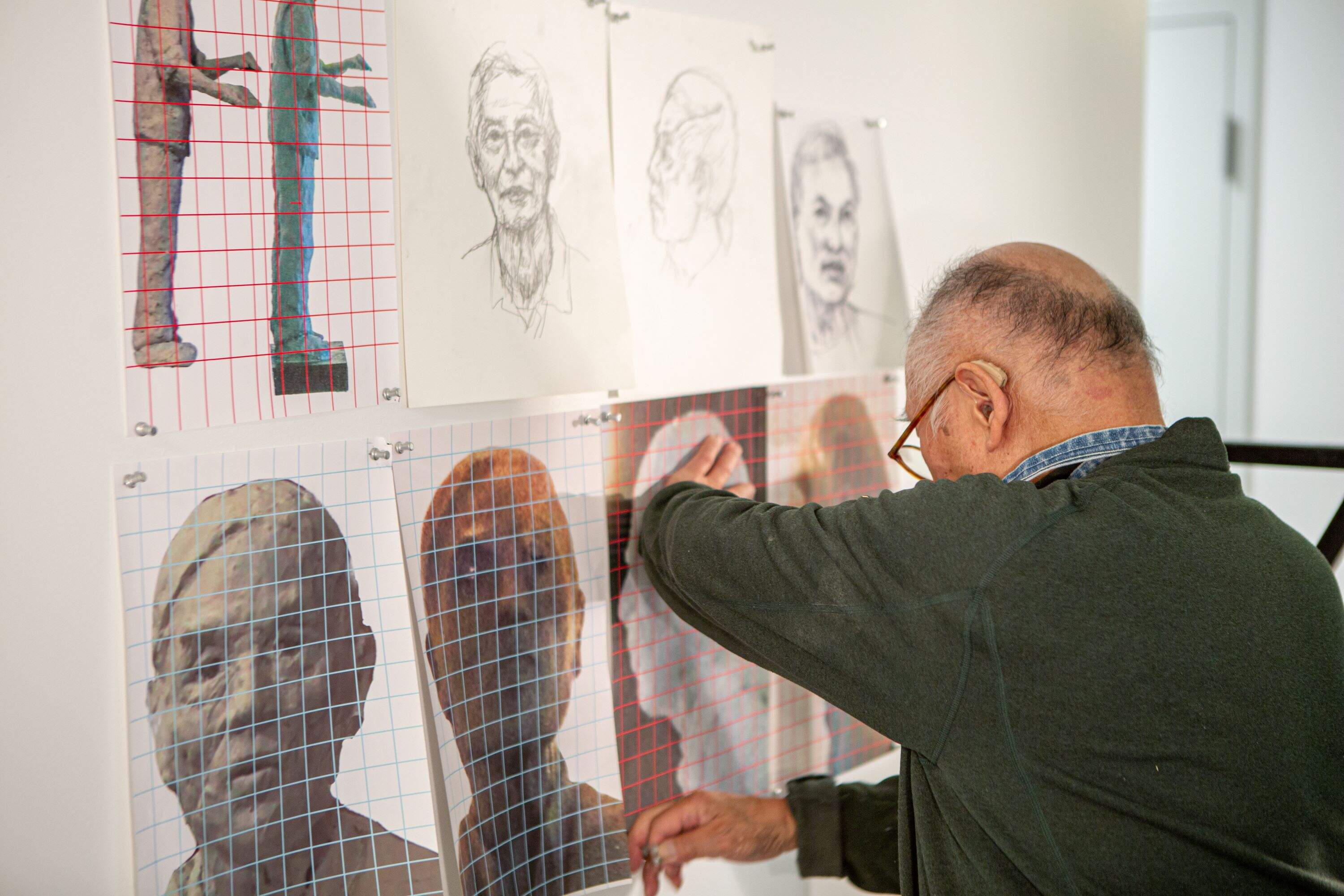Several days a week, Tsen works on the sculptures in the foyer of the Pao Arts Center, so the public can see his process as it unfolds. (Jacob Garcia/WBUR)