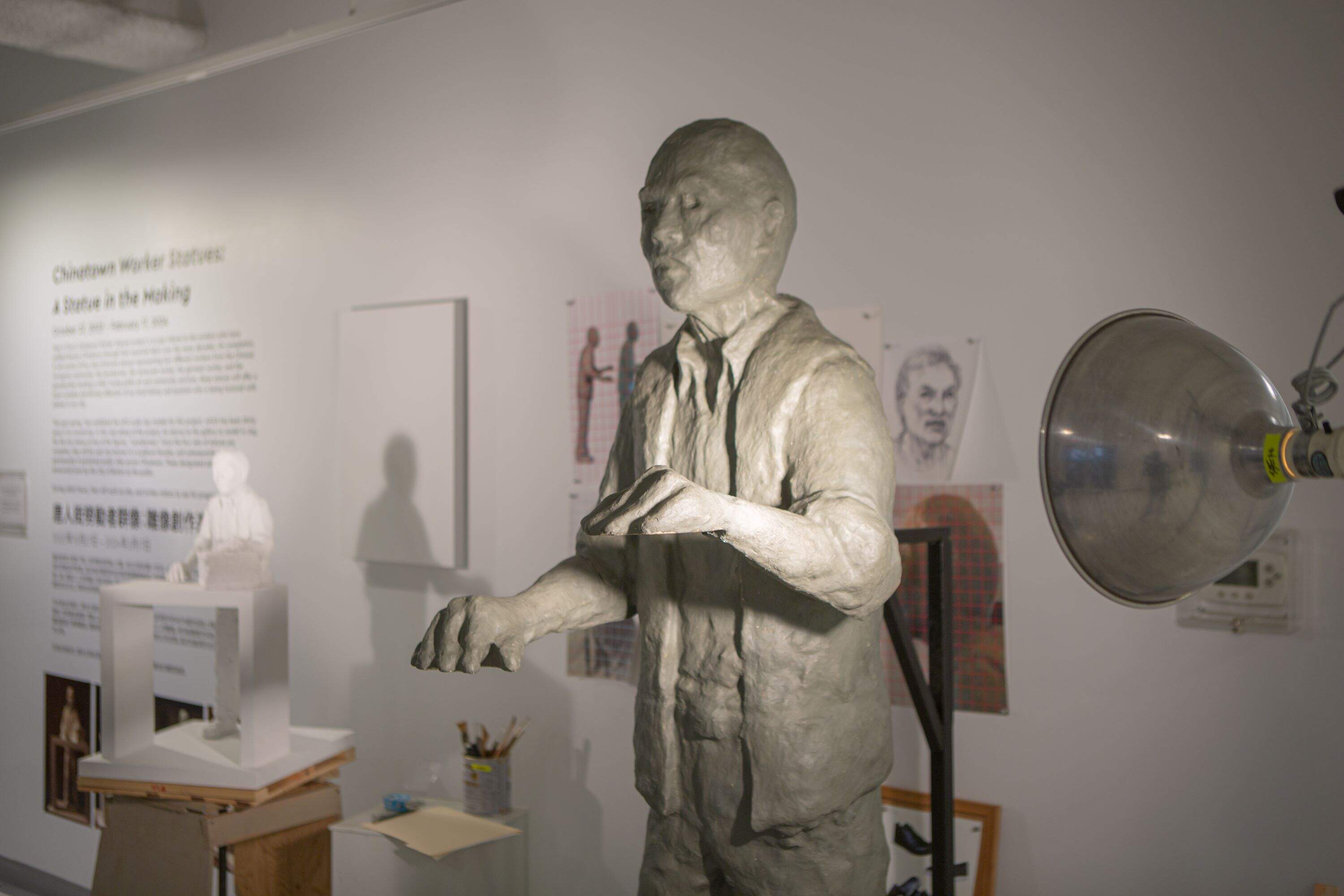 Tsen is refining a sculpture of a laundryman, one of four works that will be installed around Chinatown. (Jacob Garcia/WBUR)
