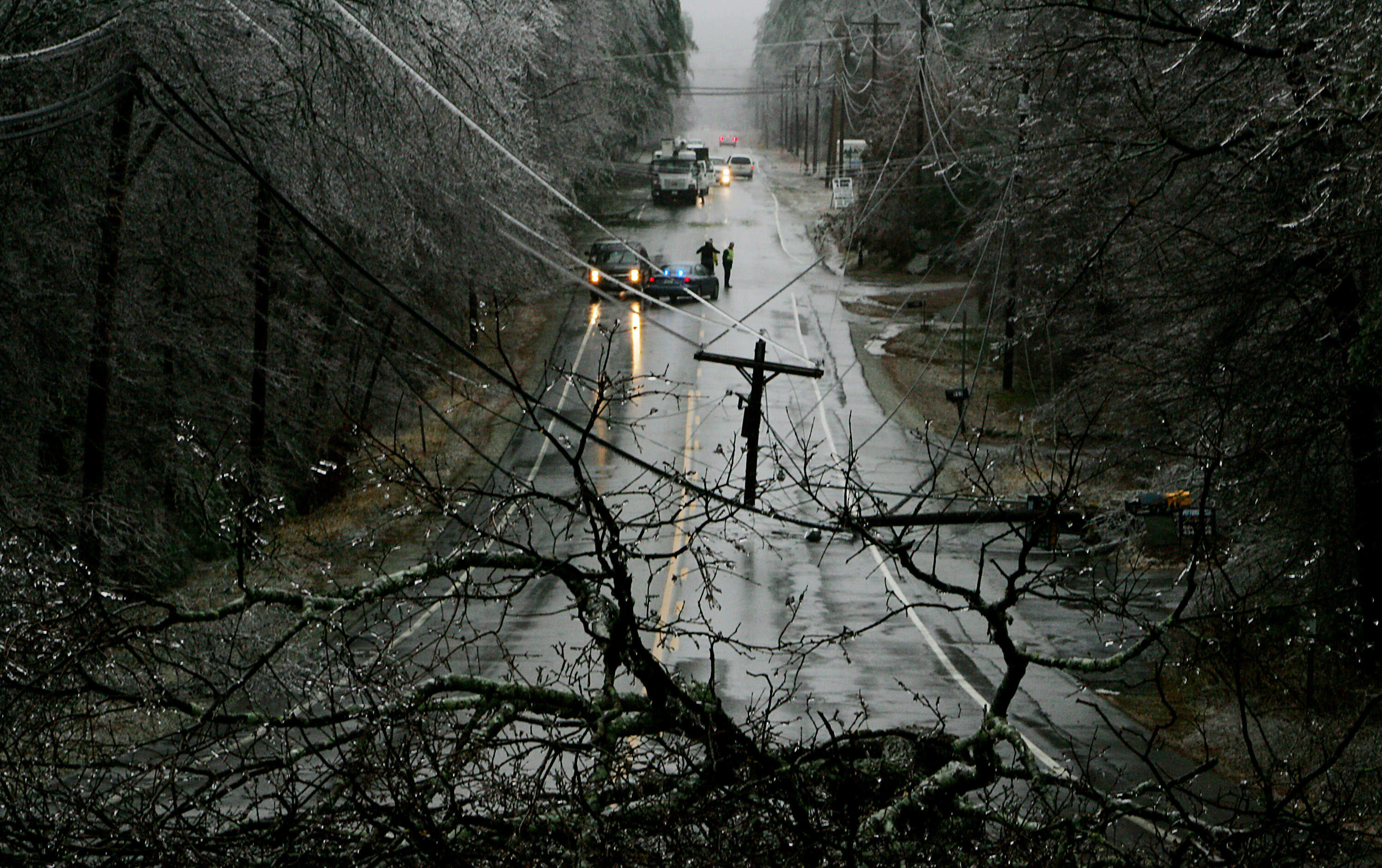 Traffic is redirected in Derry, N.H. after a utility pole snapped due to an overnight ice storm Friday, Dec. 12, 2008. The ice storm knocked out power to more than a half-million homes and businesses in New England and upstate New York. (Cheryl Senter/AP)