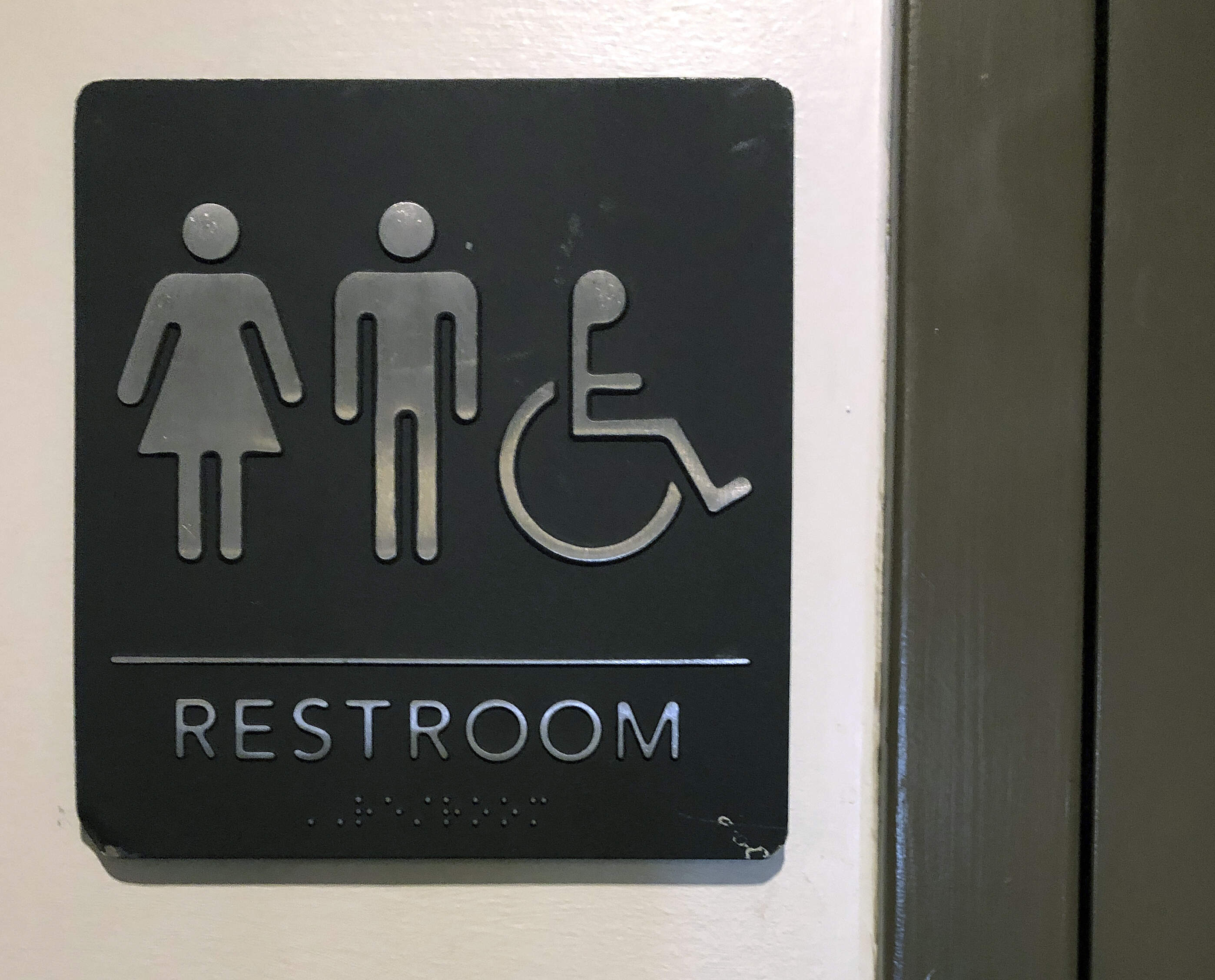 A sign is posted on a restroom door for general use by all patrons. (Bill Sikes/AP)