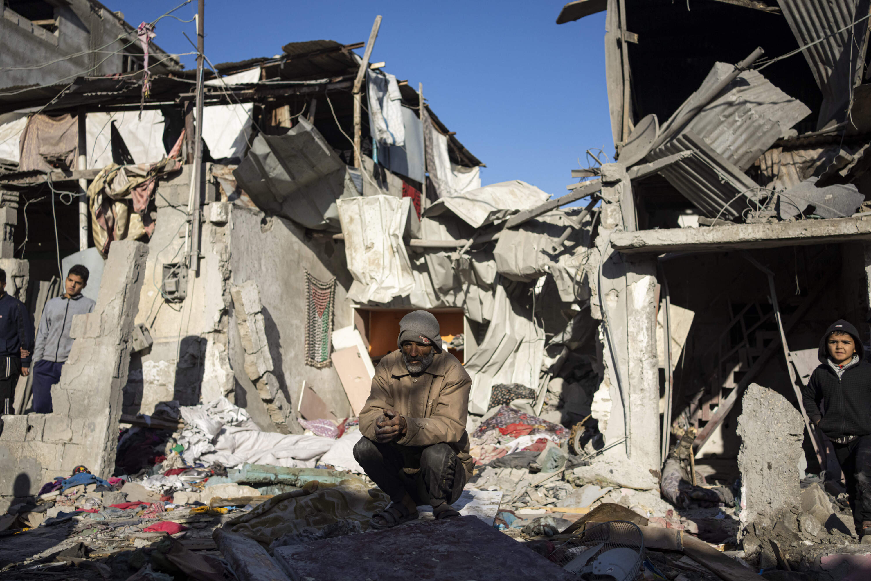 Palestinians look at the destruction after an Israeli strike in Rafah, southern Gaza Strip. (Fatima Shbair/AP)