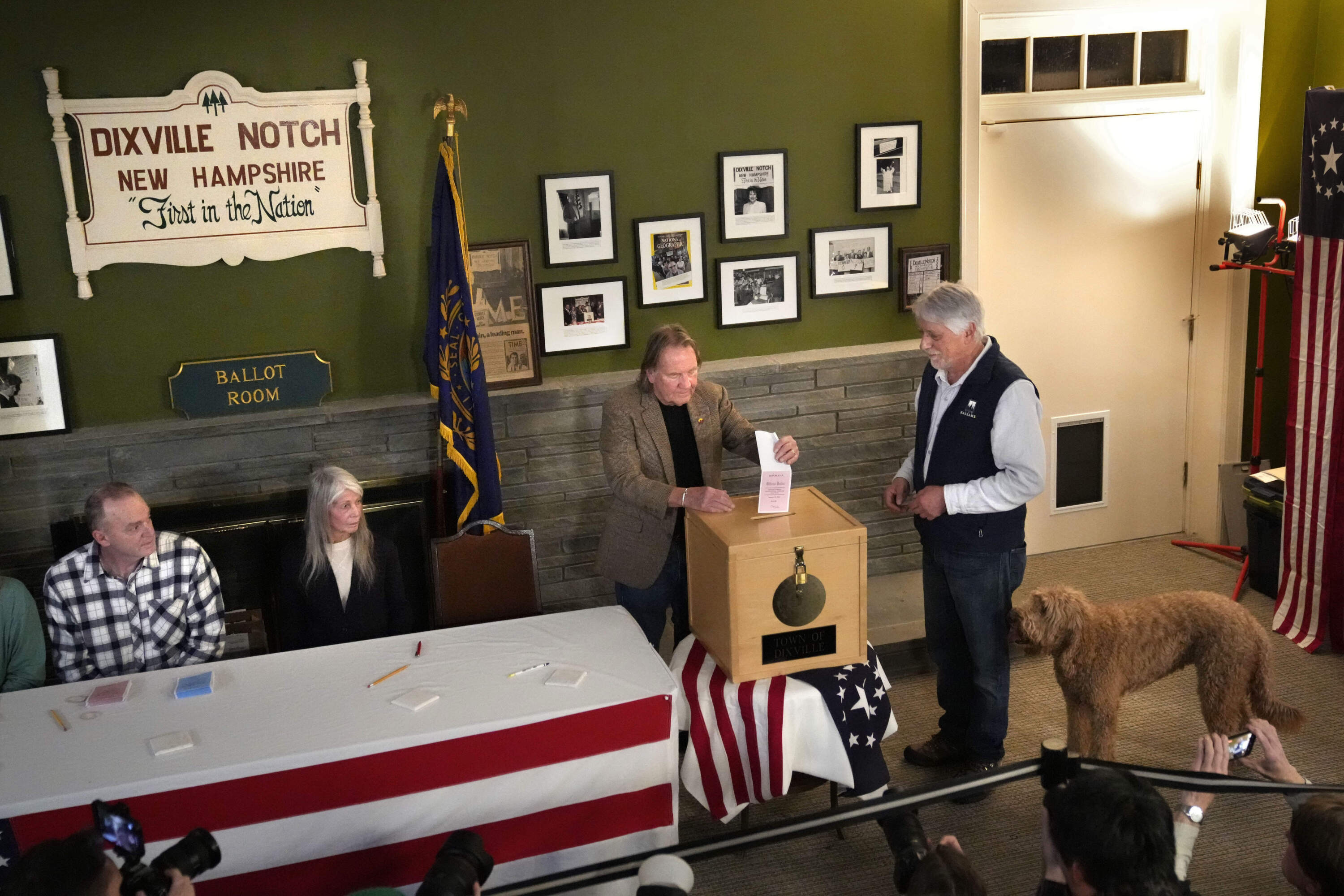 Les Otten, far right, has his vote inserted into the ballot box by town moderator Tom Tillotson shortly after midnight in the presidential primary in Dixville Notch. (Robert F. Bukaty/AP)