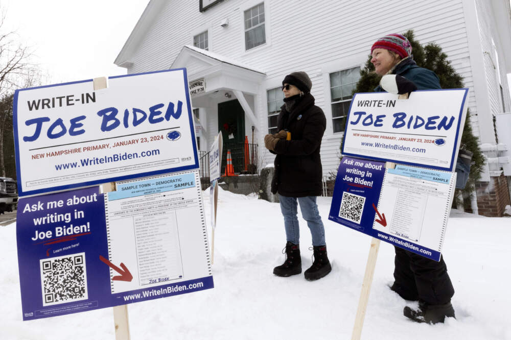 Supporters of a Joe Biden write-in campaign stand outside the Holderness Town Hall polling site during presidential primary election day. (Michael Dwyer/AP)