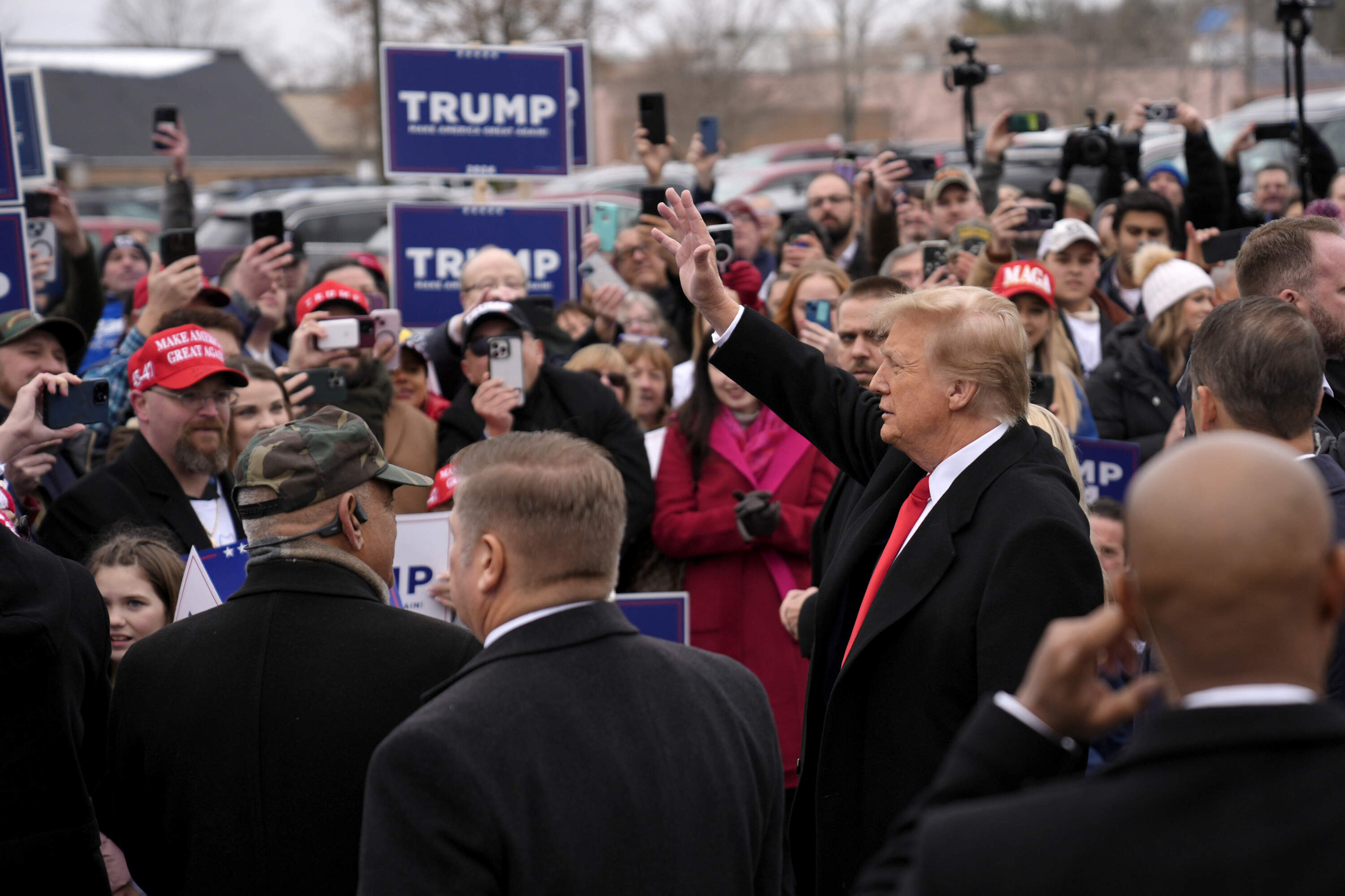 Republican presidential candidate former President Donald Trump greets supporters as he arrives at a campaign stop in Londonderry on primary day. (Matt Rourke/AP)