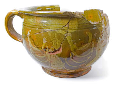 Mid-18th century chamber pot made at the Parker pottery in Charleston. Jack and Acton were potters enslaved by Grace Parker, owner of the pottery, and likely contributed to making this vessel. It was found during archeology ahead of Boston's Big Dig project in 1985 at the Three Cranes Tavern site next to the pottery. (Courtesy City of Boston Archeology Program)
