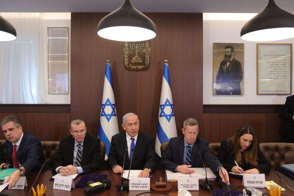 Israeli Prime Minister Benjamin Netanyahu (C), Justice Minister Yariv Levin (2-L) , Foreign Minister Eli Cohen (L) and cabinet secretary Yossi Fuchs (2-R) attend the weekly cabinet meeting in the prime minister's office in Jerusalem, on February 19, 2023. (ABIR SULTAN/POOL/AFP via Getty Images)