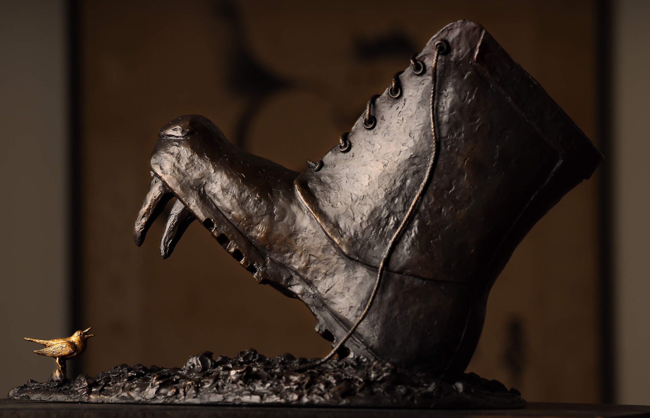 The boot features the fangs and snout of a Russian bear. Nancy Schon, the 95-year-old sculptor best known for the iconic "Make Way for Ducklings" statue in the Boston Common, has created a new piece commenting on the horror in Ukraine. It depicts a Russian boot about to step down on a nightingale, the national bird of Ukraine. (Lane Turner/The Boston Globe via Getty Images)