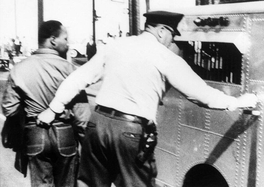 A police officer in Birmingham, Alabama grabs Rev. Martin Luther King, Jr., by the seat of his trousers in jailing him for leading an anti-segregation march on April 12, 1963. (Getty Images)