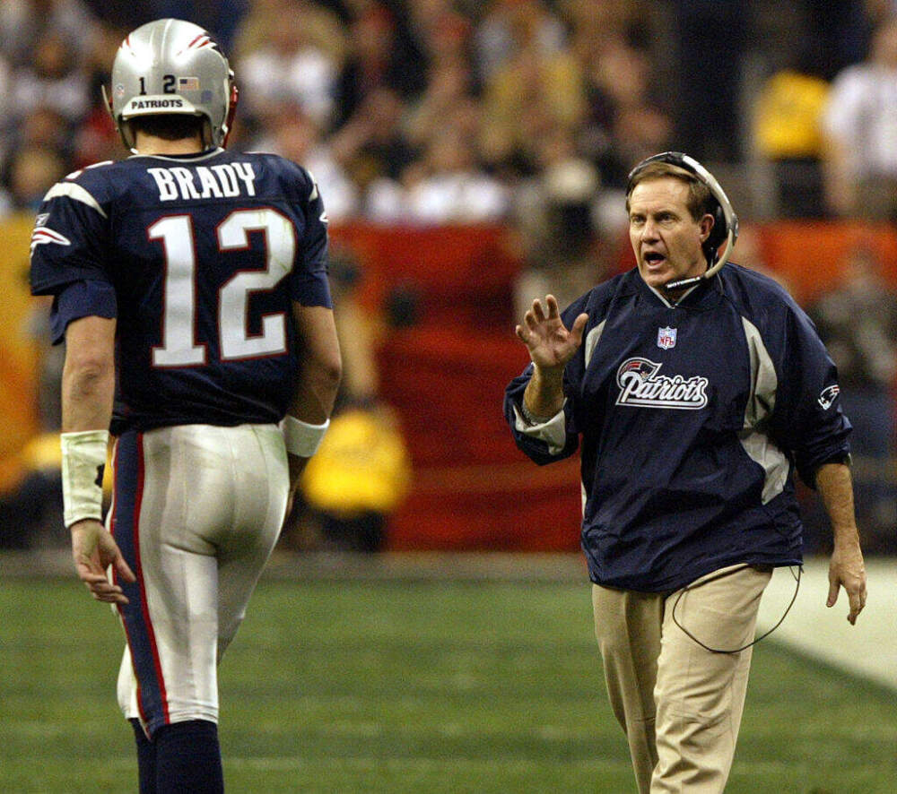 On their way to their second Super Bowl victory together in the last three years, Patriots head coach Bill Belichick, right, gives some instructions to quarterback Tom Brady. New England Patriots face the Carolina Panthers in Super Bowl XXXVIII at Reliant Stadium in Houston, TX on Feb. 1, 2004. (Jim Davis/The Boston Globe via Getty Images)