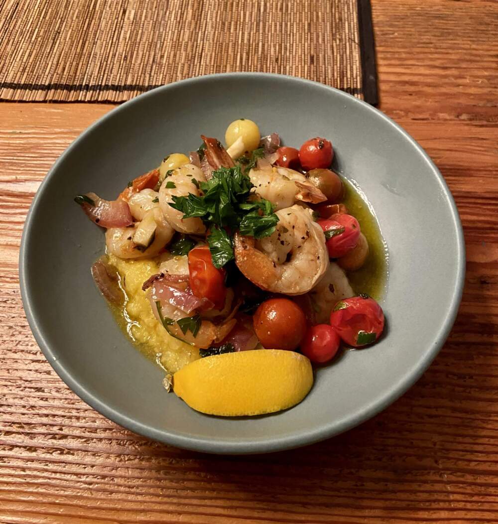 Sauteed garlic shrimp over polenta with slow-roasted cherry tomatoes. (Kathy Gunst/Here & Now)