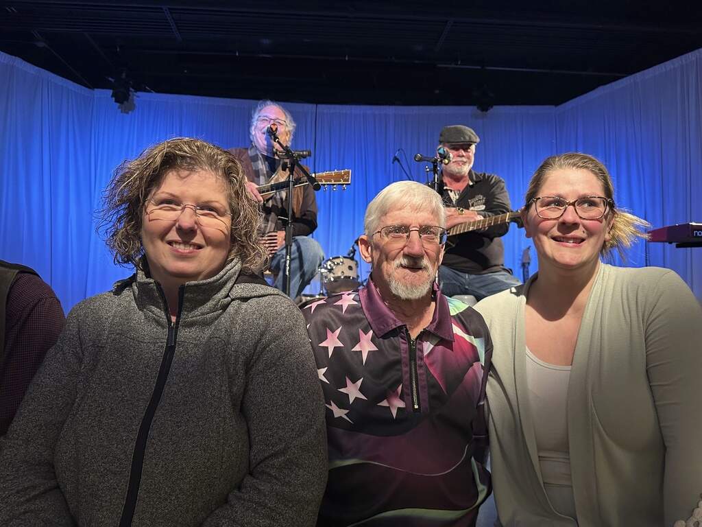 From left, Kathy Lebel, Tom Giberti and Samantha Juray, attend a benefit concert in Lewiston, Maine. (Nick Perry/AP)