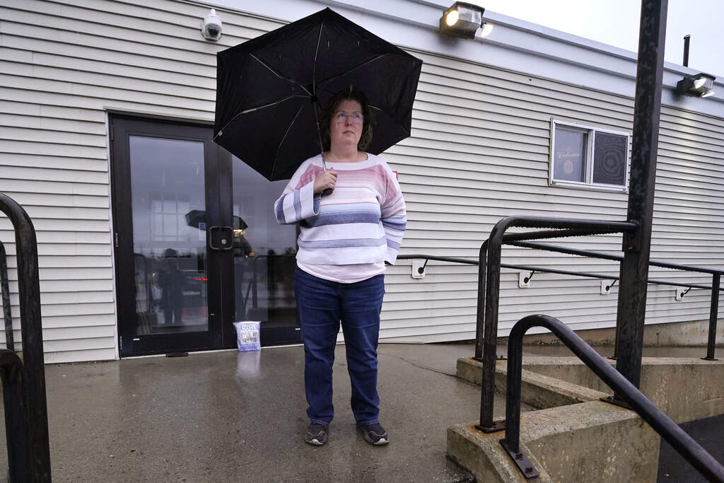Kathy Lebel, the owner of Schemengees Bar &amp; Grille, which is currently closed after the mass shootings, stands for a portrait in Lewiston, Maine. (Charles Krupa/AP)