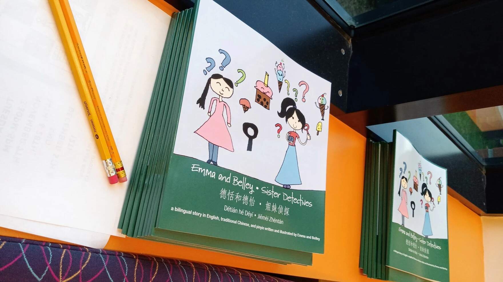 "Sister Detectives" is a book in English and Chinese, with transliteration for young readers, written by two young readers from Orange, Massachusetts, Emma and Belley Barrett. (Jill Kaufman/NEPM)