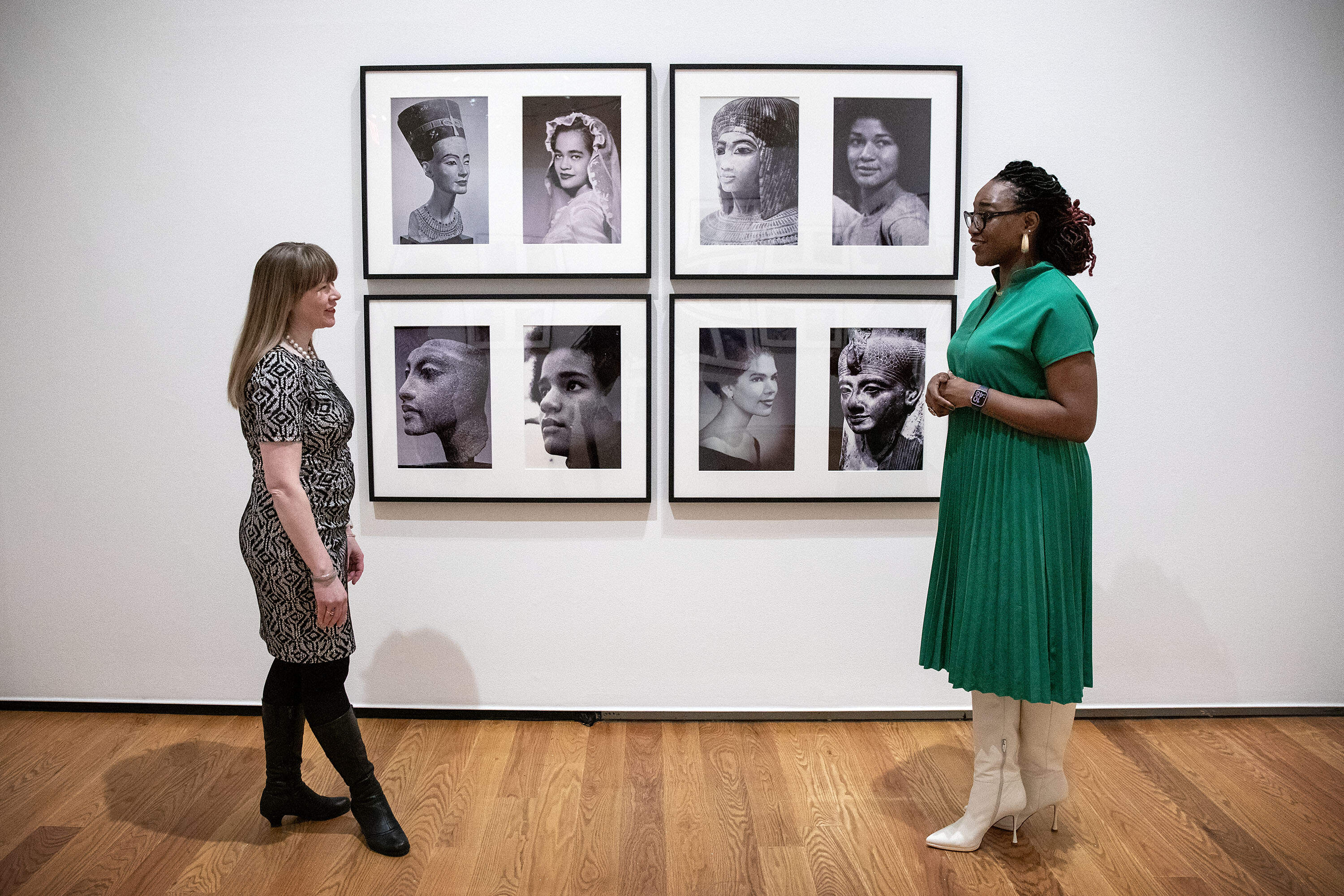 From left, Wellesley curator Amanda Gilvin and scholar Nikki Greene at the "Miscegenated Family Album" section of the "Both/And" exhibit of Lorraine O'Grady's work, at Wellesley's Davis Museum. (Robin Lubbock/WBUR)