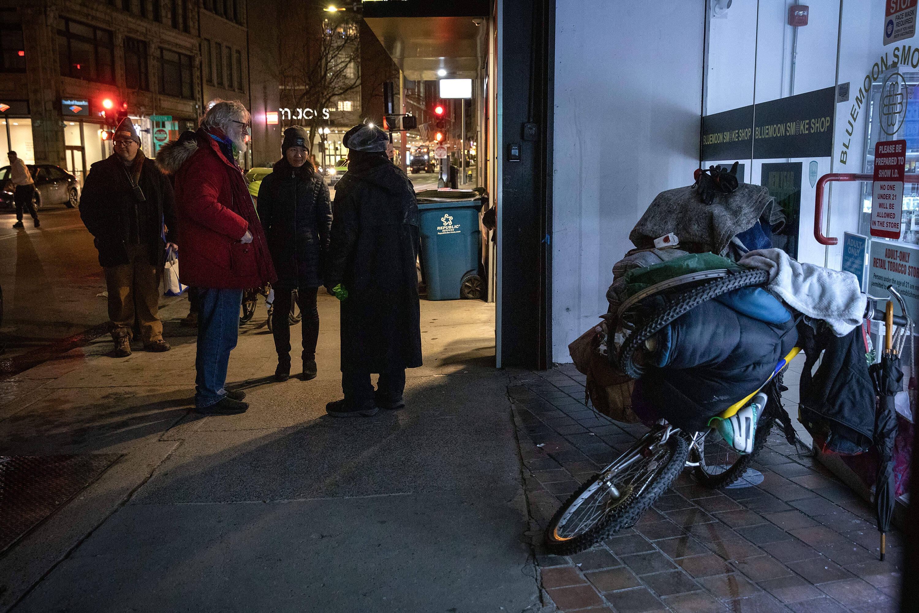 Mayor Michelle Wu and Jim Greene, the city's assistant director of street homelessness initiatives, talk with a man experiencing homelessness. (Robin Lubbock/WBUR)