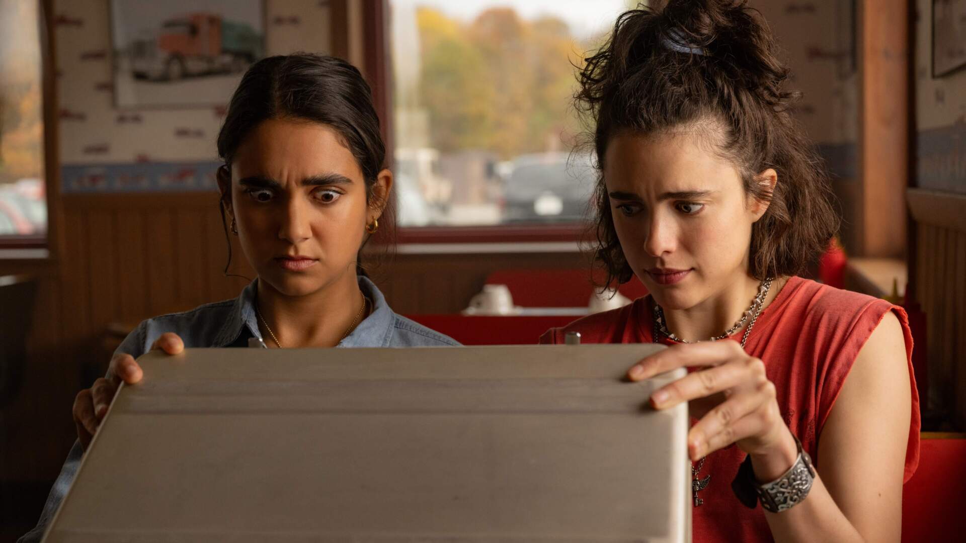 Geraldine Viswanathan (left) and Margaret Qualley in &quot;Drive-Away Dolls.&quot; (Courtesy Wilson Webb/Working Title/Focus Features)